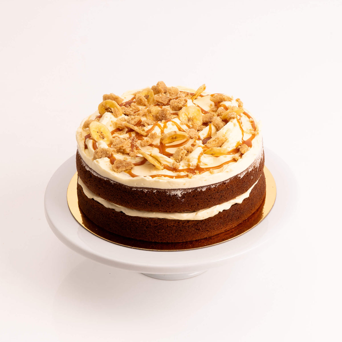 Moist banana cake with cream cheese frosting and caramel drizzle by Sweet Talk, available for delivery in Auckland.