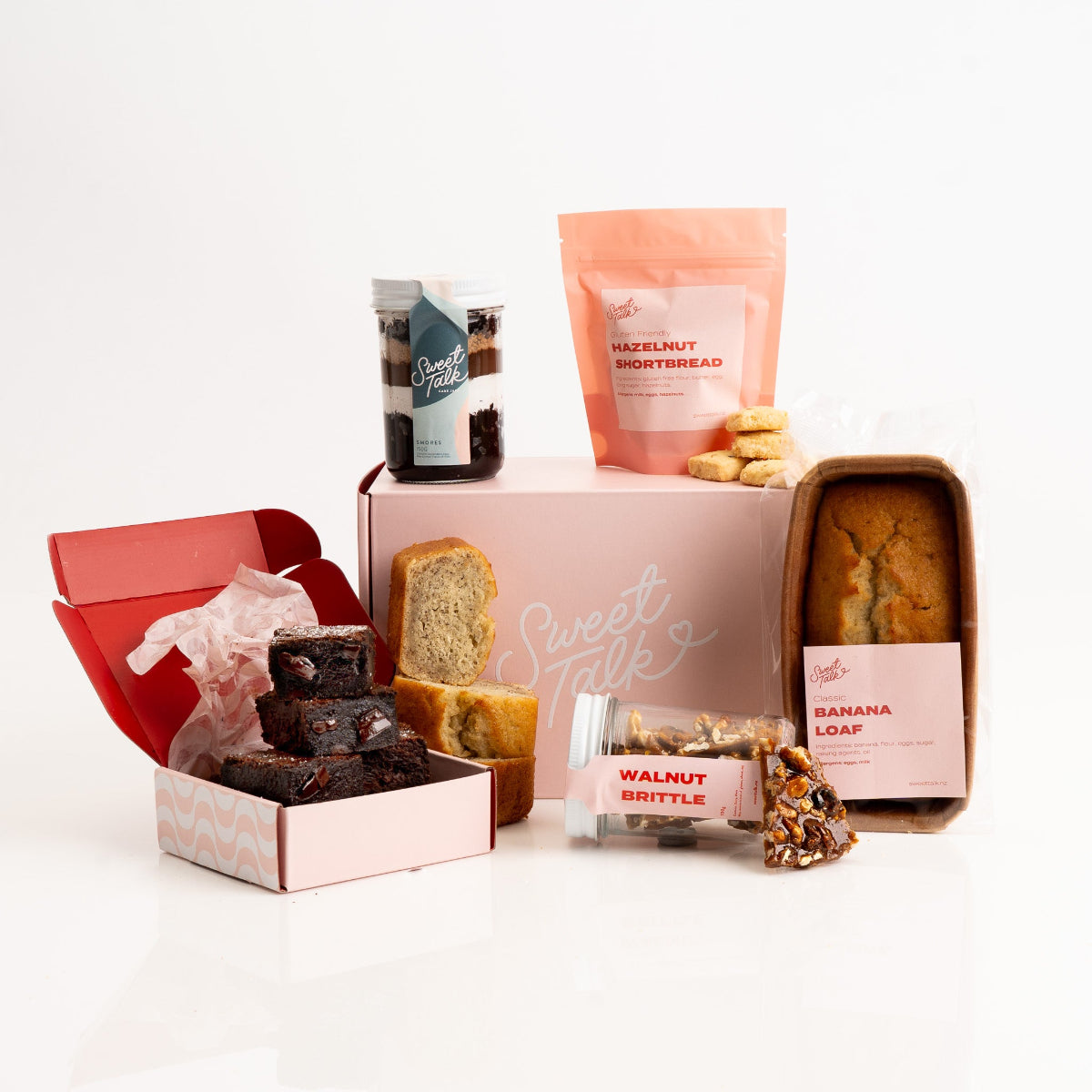 Assorted dessert gift box with sweet treats including brownie and banana loaf.