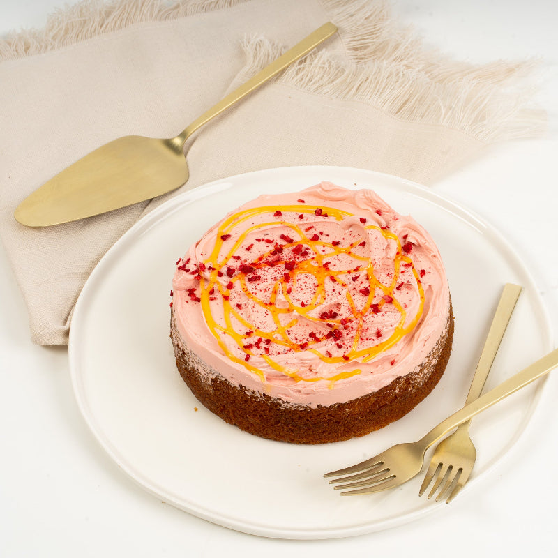 Close-up of lemon sponge layered with raspberry filling and buttercream.