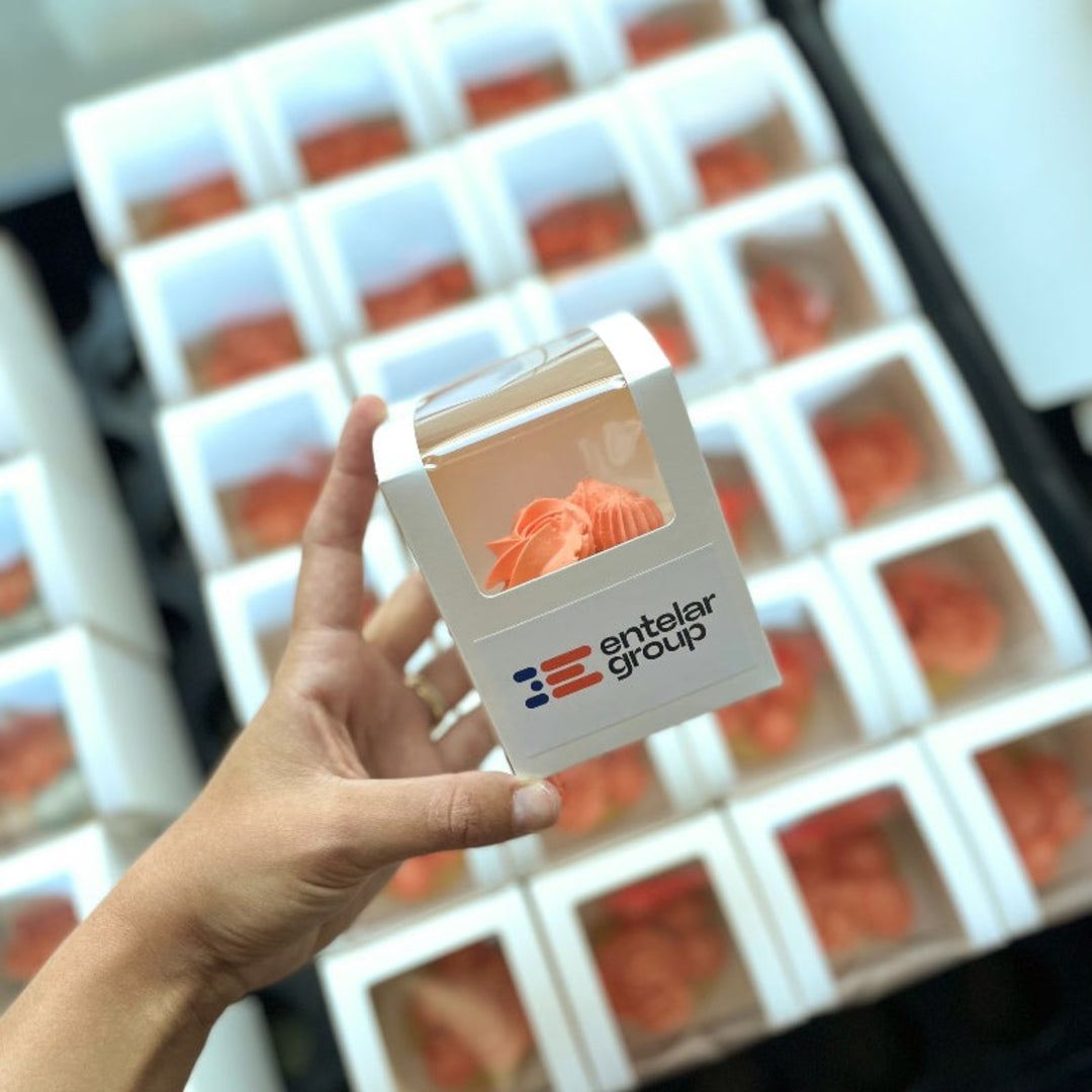 Individually boxed custom logo cupcakes for corporate events and promotions.
