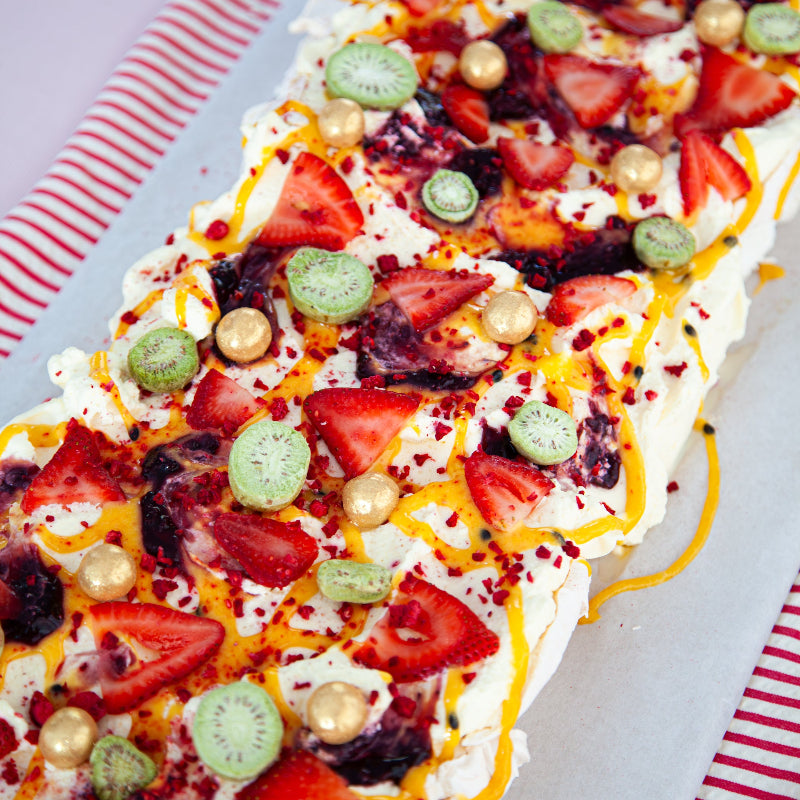Top view of Sweet Talk’s iconic Christmas pavlova with cream, strawberries, passionfruit curd and freeze-dried kiwi berries.