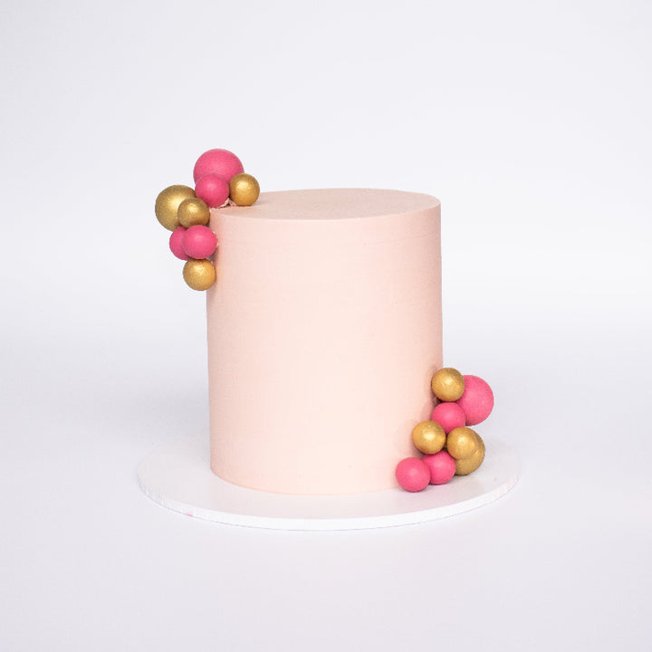 Celebration cake featuring edible chocolate bubbles and custom colour design.