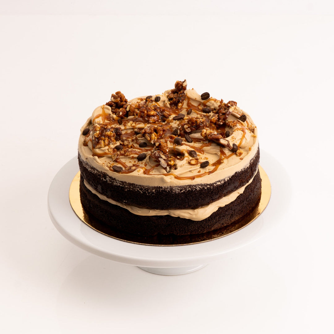 Whole chocolate cake with espresso buttercream and glossy caramel finish.
