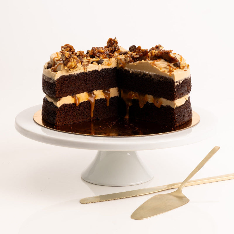 Slice of rich chocolate and espresso cake topped with pecan crumble.
