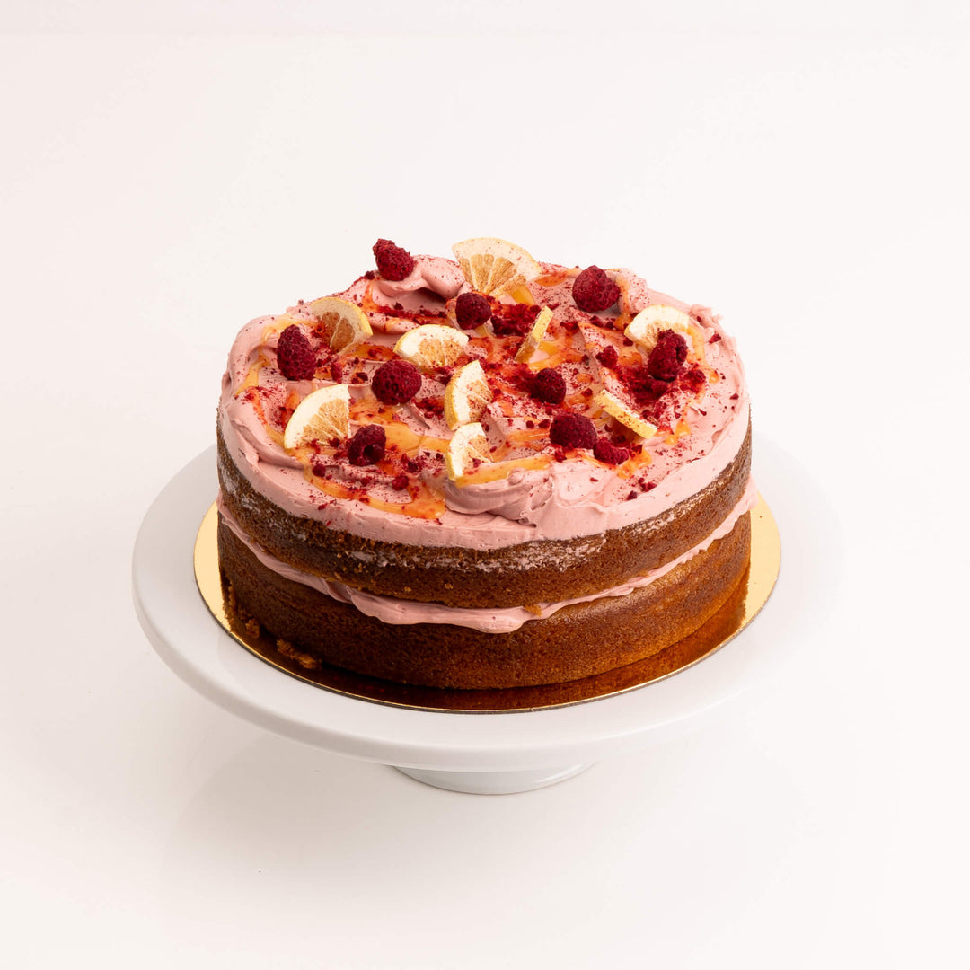 Lemon & Raspberry cake layered with zesty curd, raspberry compote, and cream.
