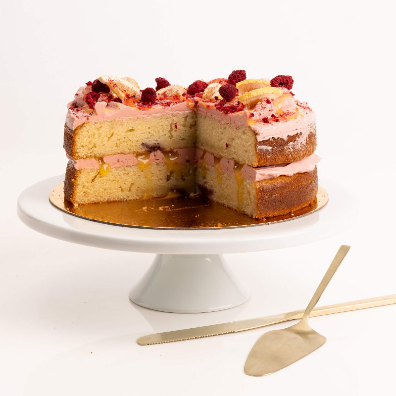Lemon sponge cake topped with raspberry buttercream and fresh zest.
