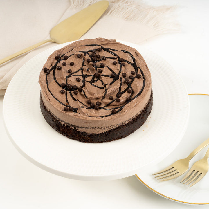 Moist chocolate layer cake topped with glossy chocolate frosting.