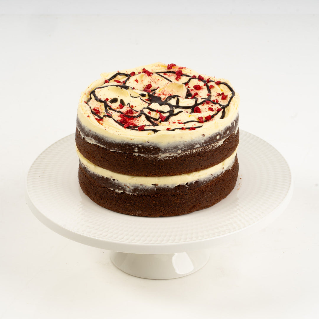 Close-up of red velvet cake topped with tangy cream cheese icing