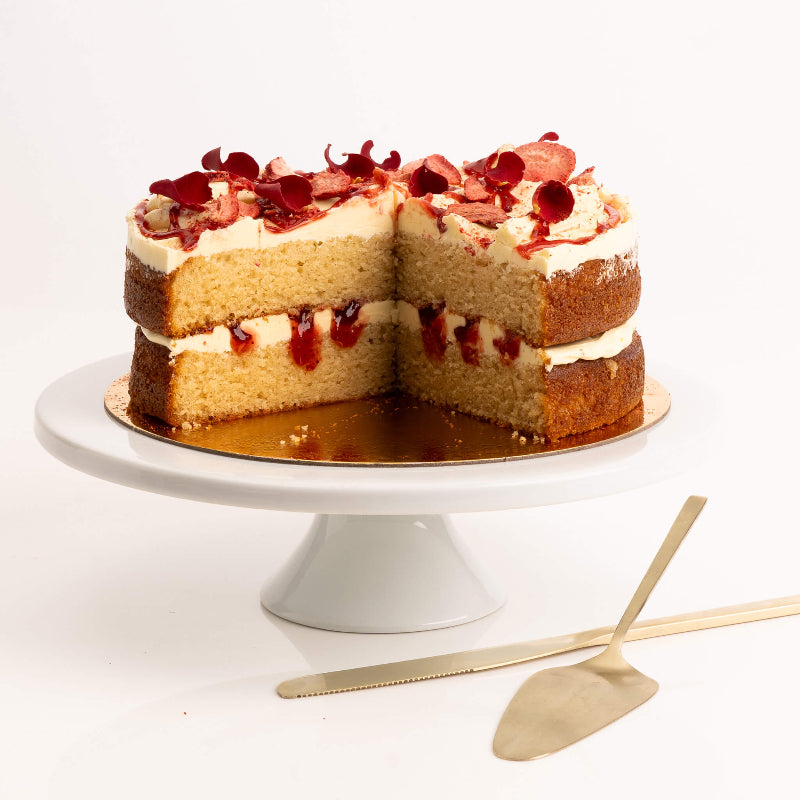 Light strawberry cake topped with whipped buttercream and fresh berries.