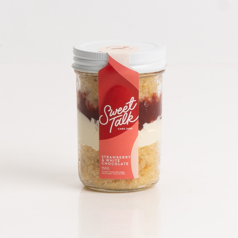 Layered strawberry and white chocolate dessert in a cake jar.