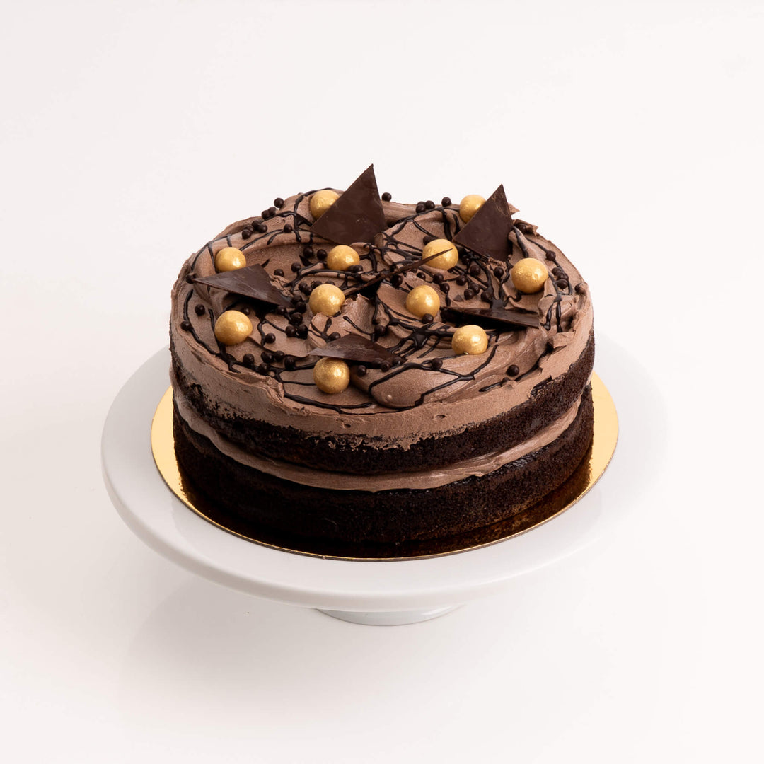 Triple chocolate cake layered with dark, milk, and white chocolate ganache.