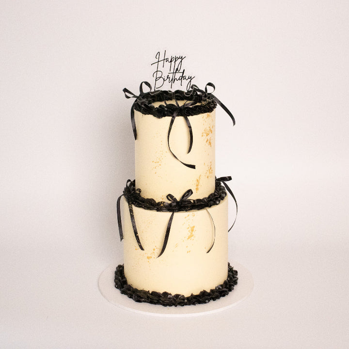 Elegant vintage-style cake with decorative piping and sprinkles.