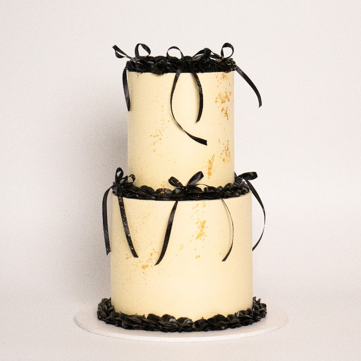 Custom vintage cake topped with coloured icing and gold accents.