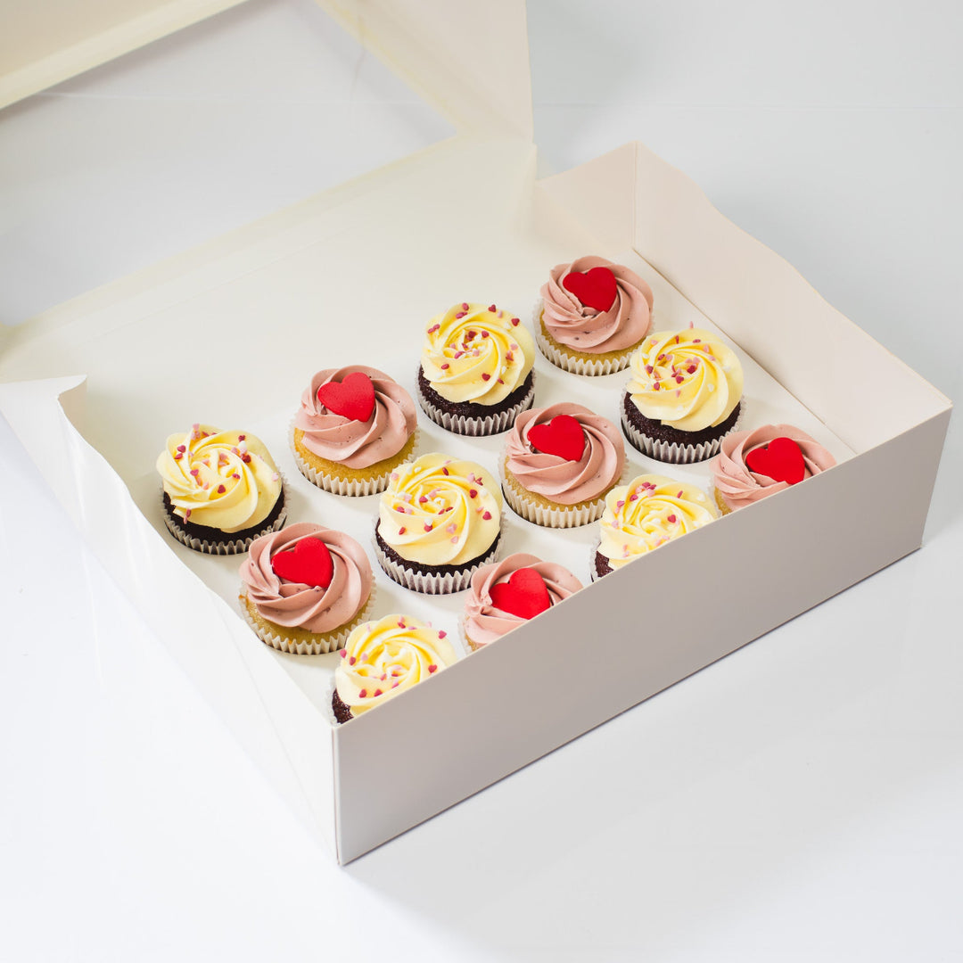 Valentine’s cupcakes with red velvet and vanilla raspberry flavours, decorated with heart details and red fondant hearts