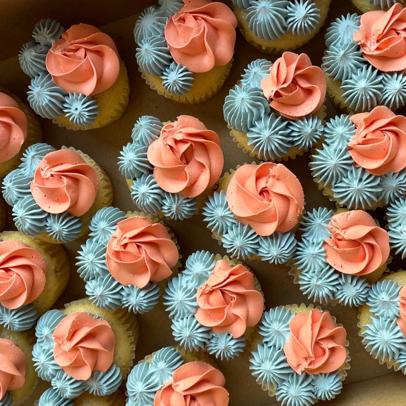 Cupcakes branded with edible logo toppers, iced in company colours.